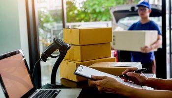 Delivery service courier driver driving with with boxes in hands. Delivery concept.